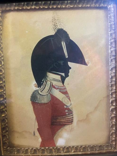 A framed picture of a person in a uniform

AI-generated content may be incorrect.